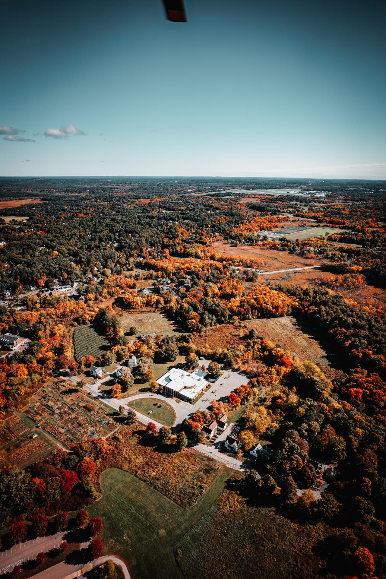 New England countryside blanketed in orange and red fall foliage